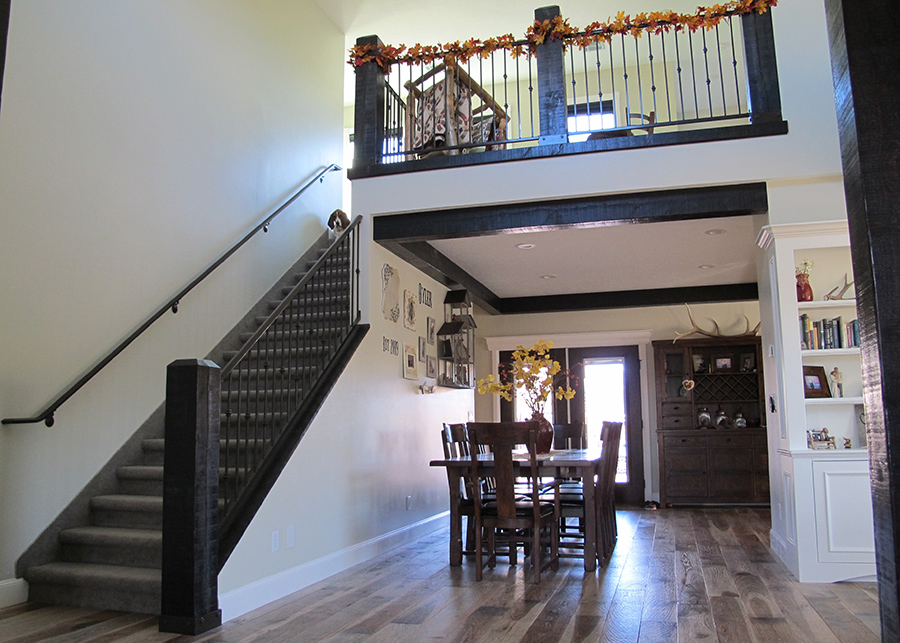 An entryway shows stairs leading to the second floor, and a small country style dining area